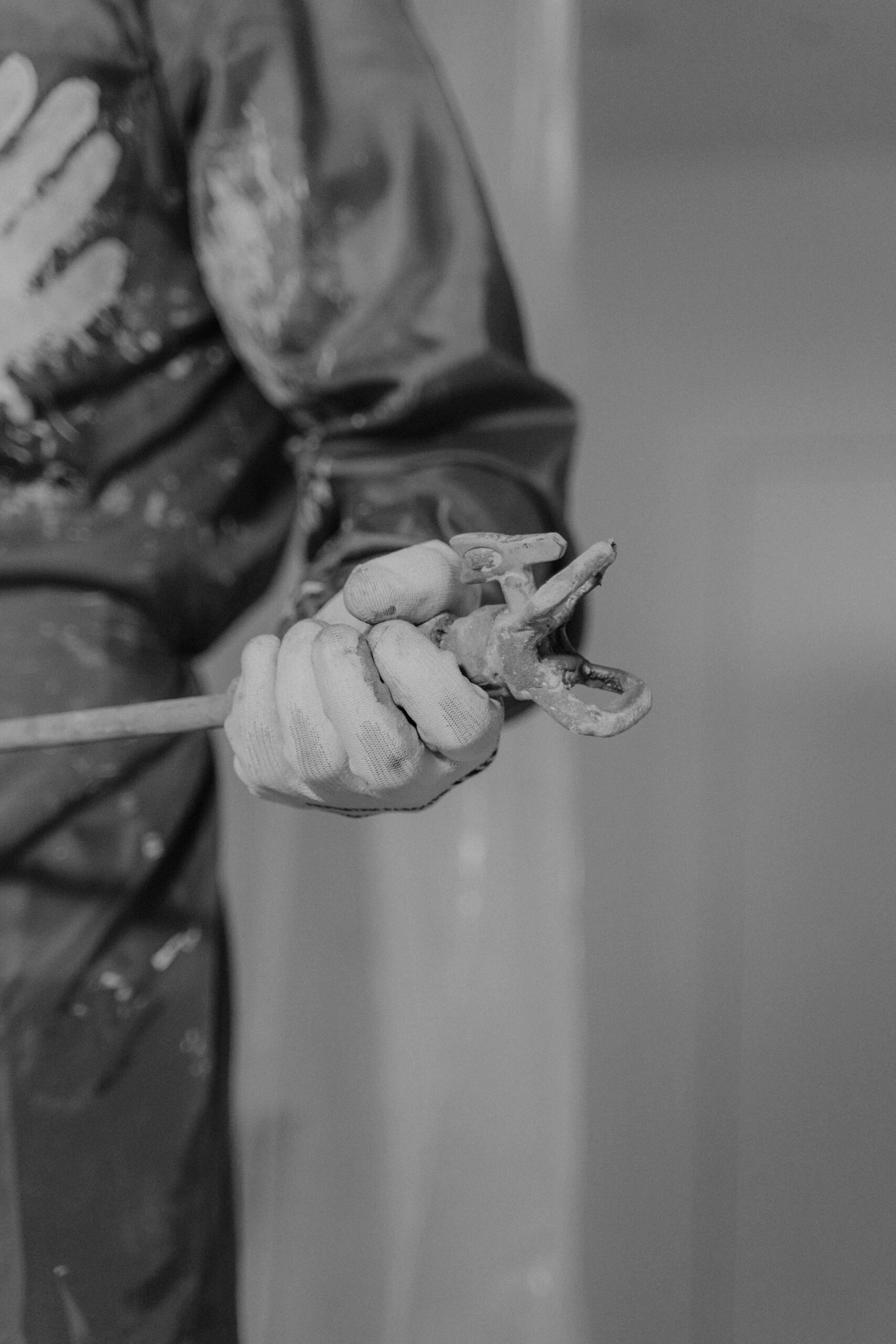 frost damage repair on renders tool clamp held by a gloved hand during external rendering application