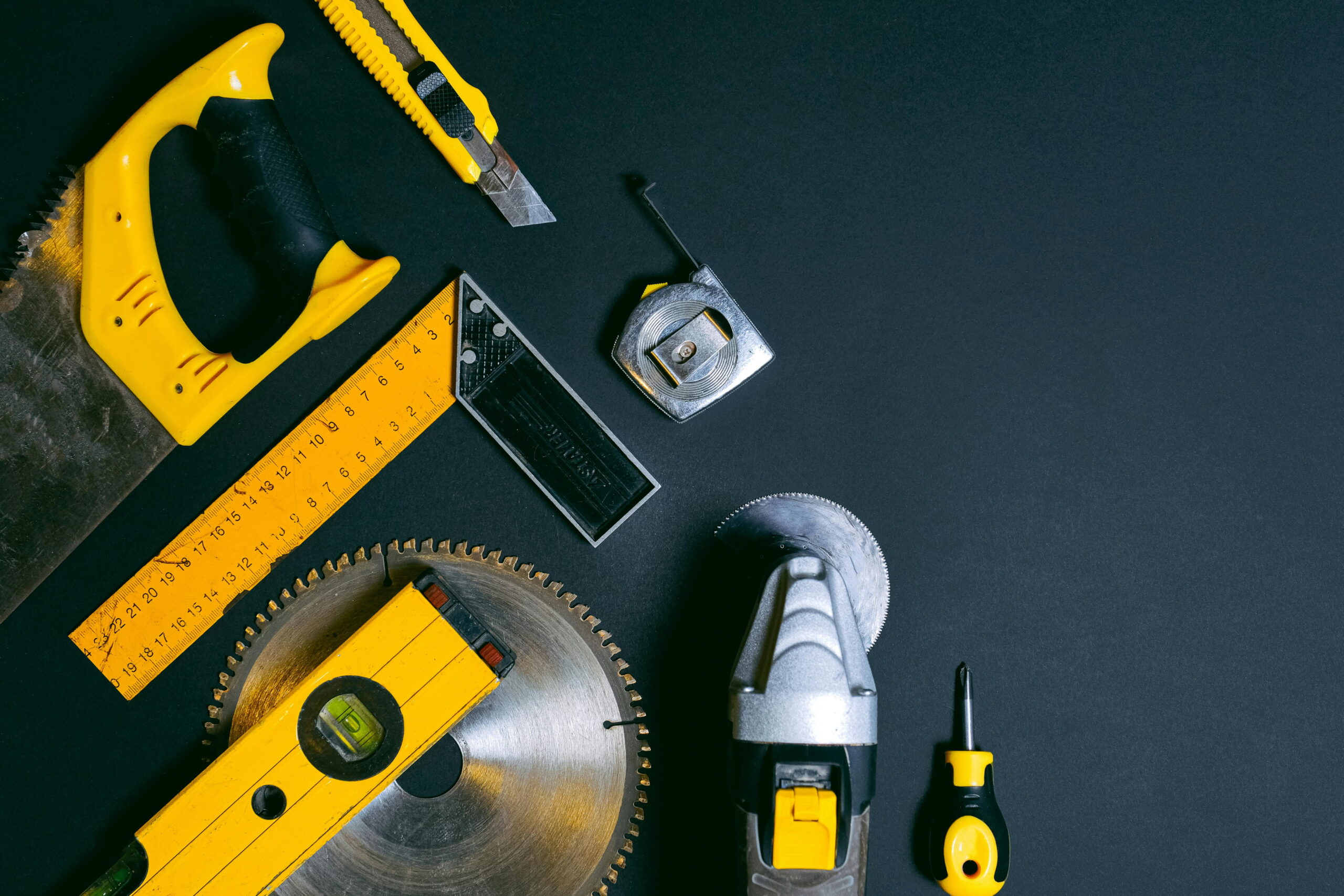 Assorted construction tools for choosing the right plastering trowel and rendering materials