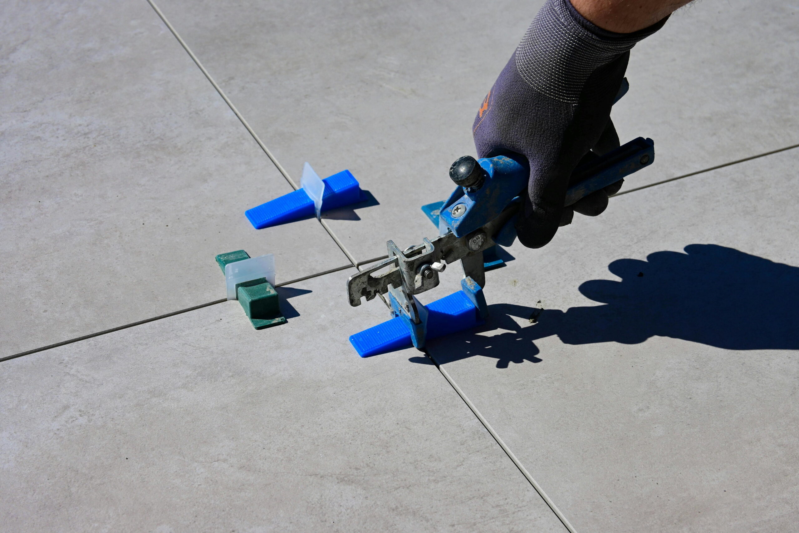 Tile leveling clamps and spacers with extension pole safety tips