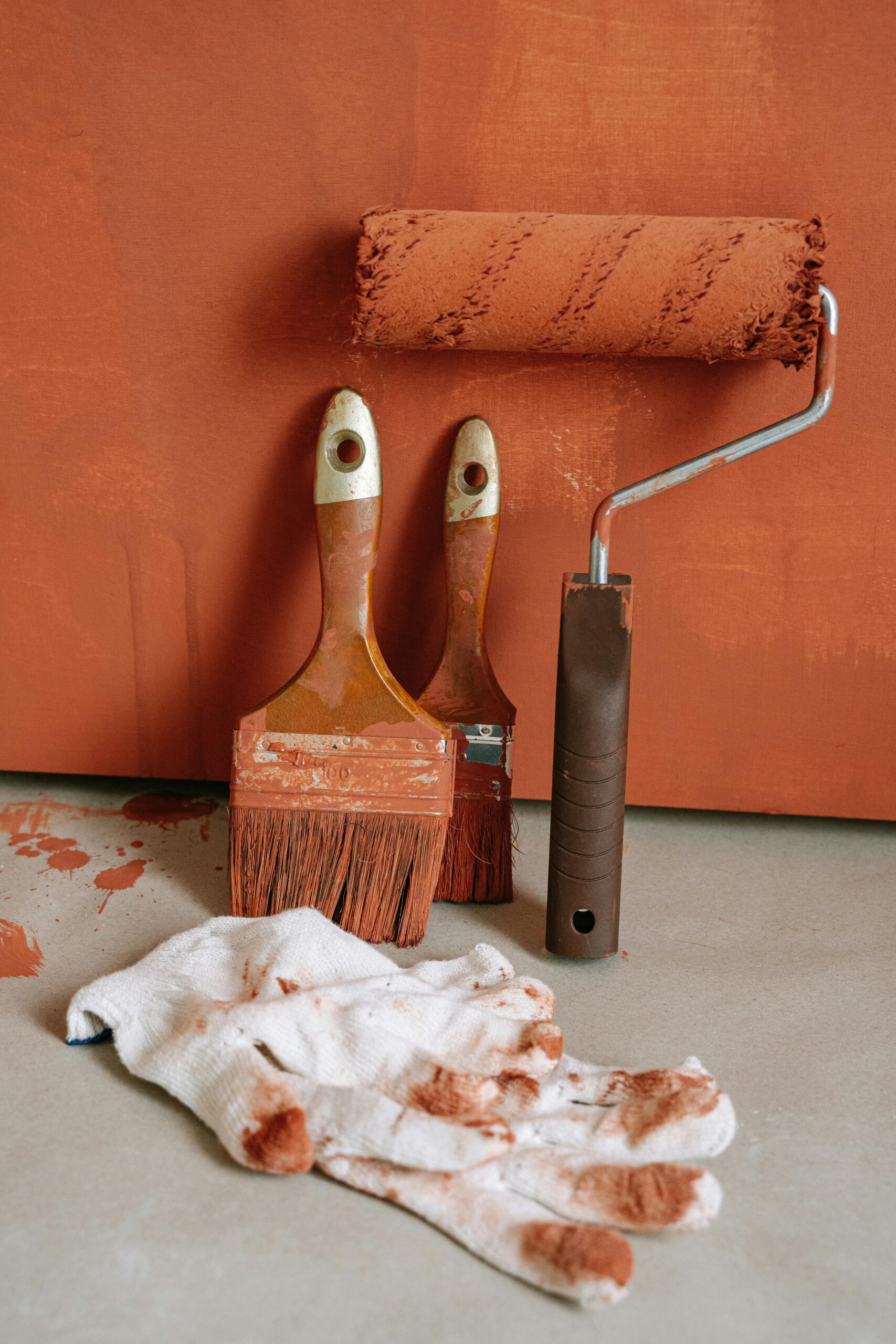 Cleaning render tools for longevity with brushes and rollers on orange render surface