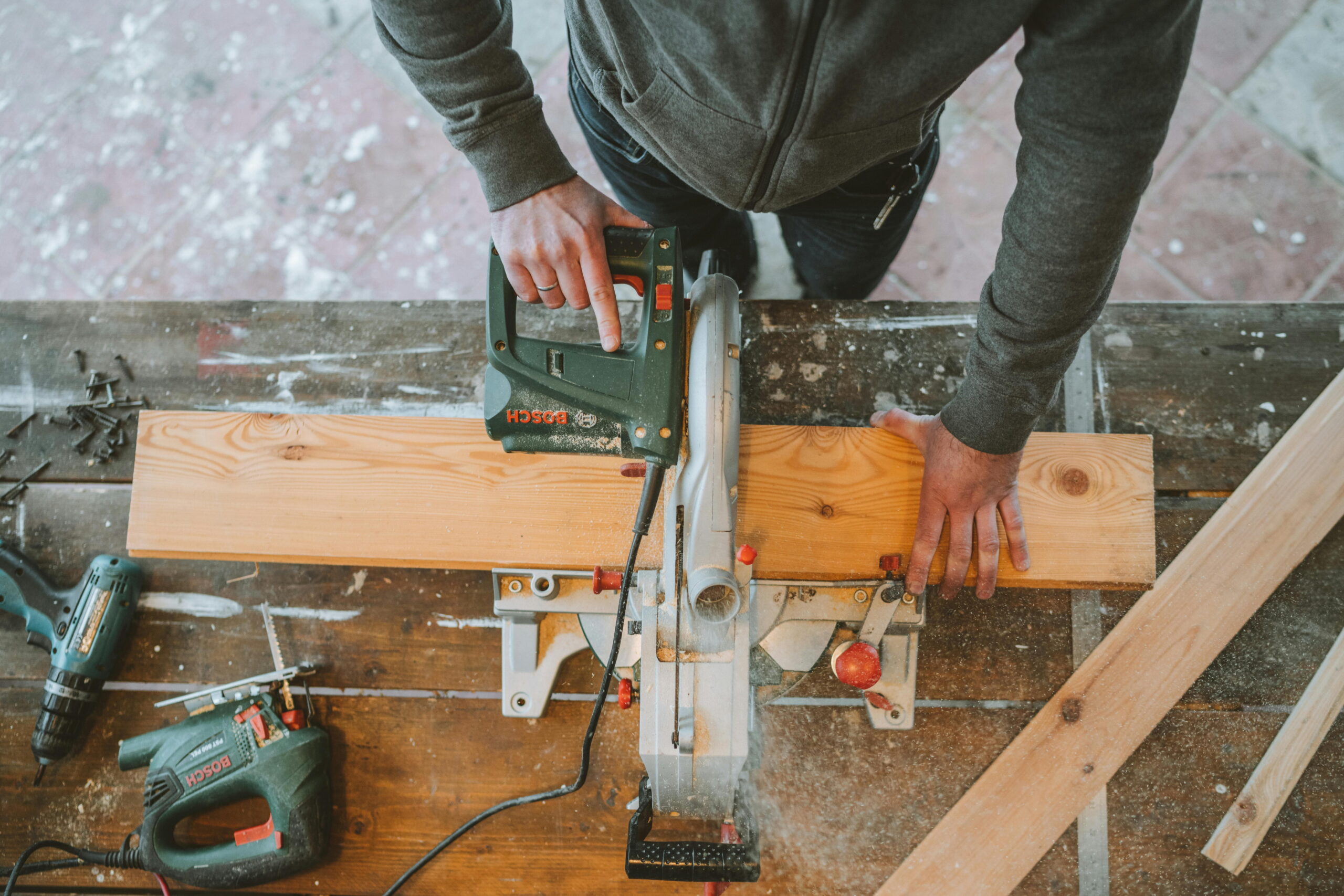Tradesperson cutting external wall insulation board EPS vs mineral wool insulation boards