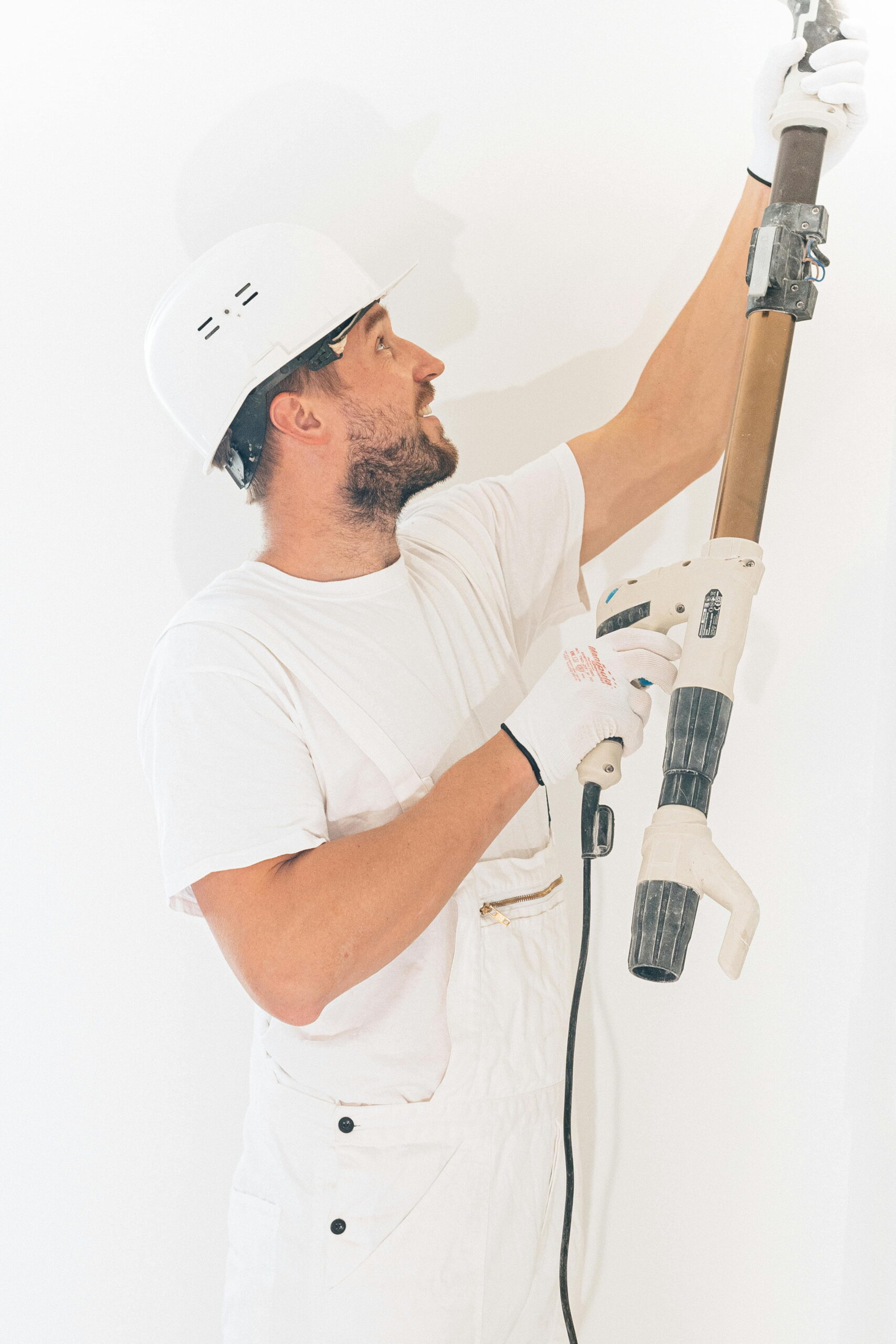 Worker applying render using tools in render colour chart guide for external wall insulation