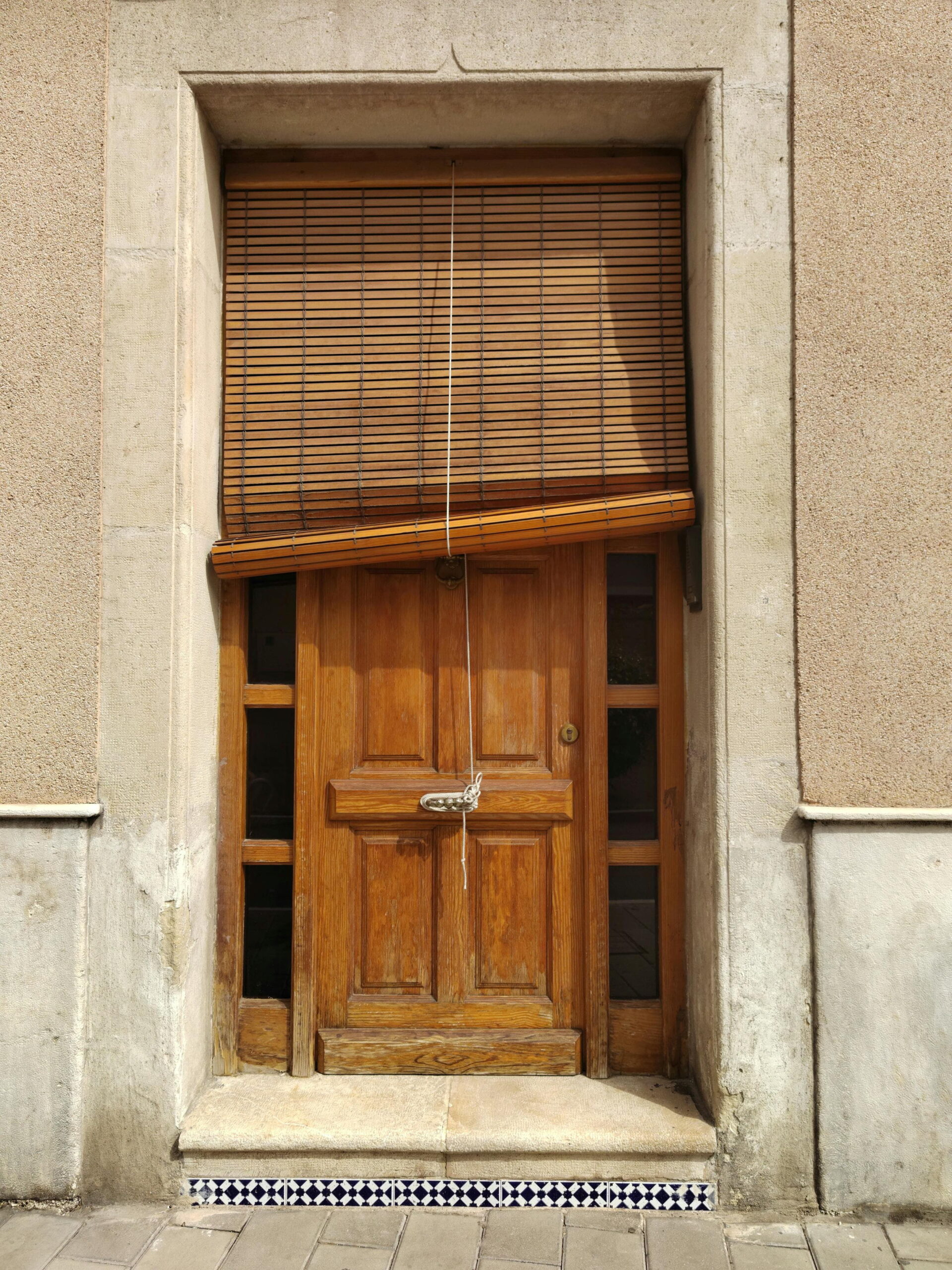 Removing old render safely from a traditional wooden door and beige stucco wall exterior by Simple Solution 4 U Ltd experts