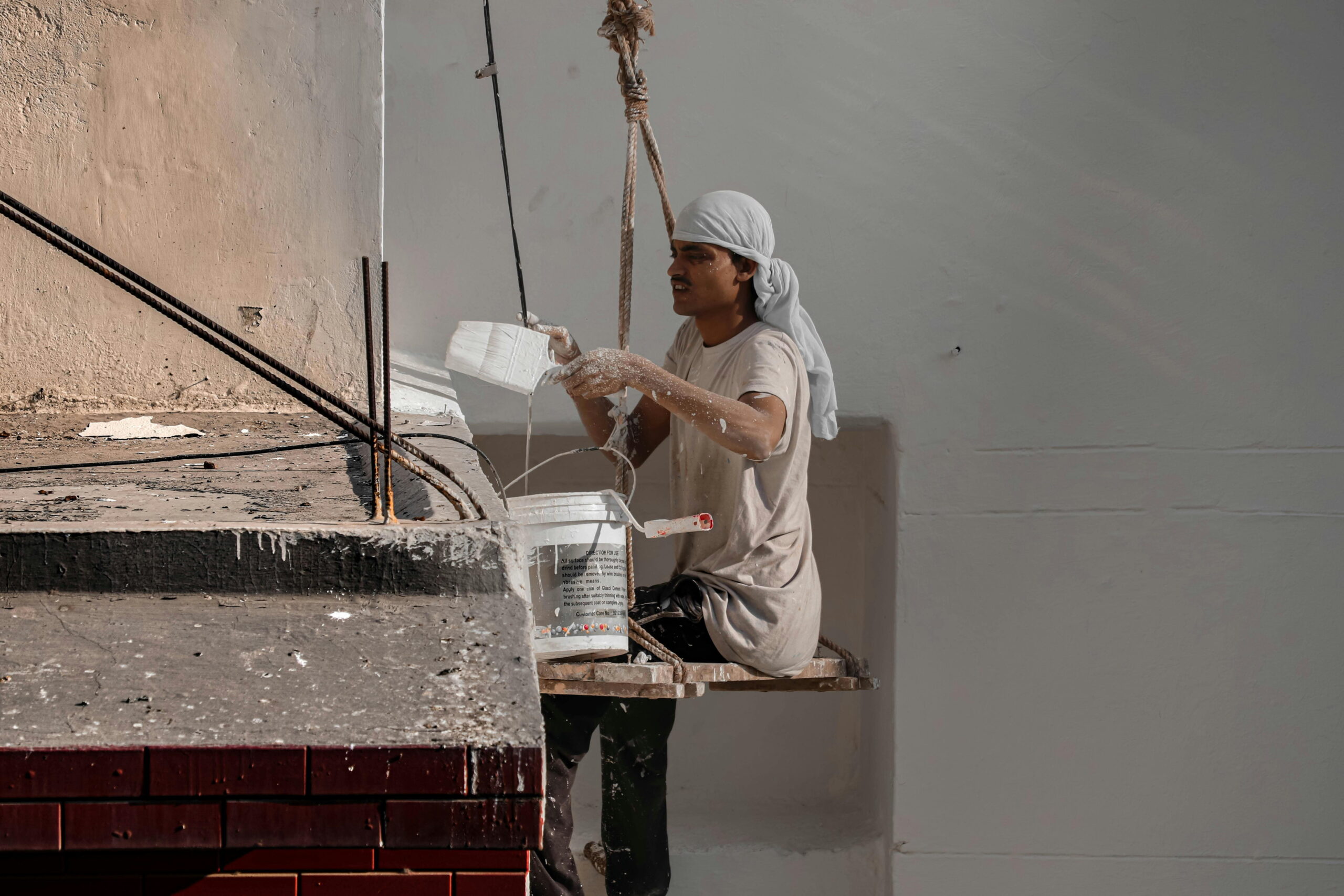 Professional worker applying interior plaster in winter conditions, emphasizing curing times for interior plaster in winter for optimal results