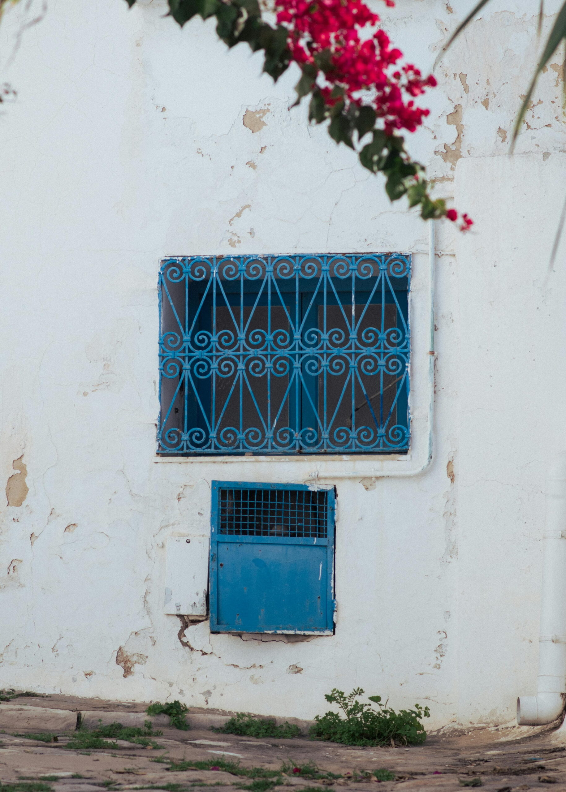 installing trickle vents in new windows with blue grilles and render finish