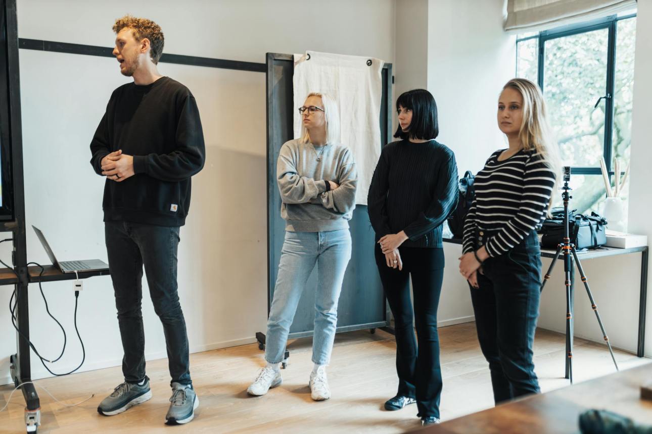A diverse team in a modern office setting during a professional presentation.