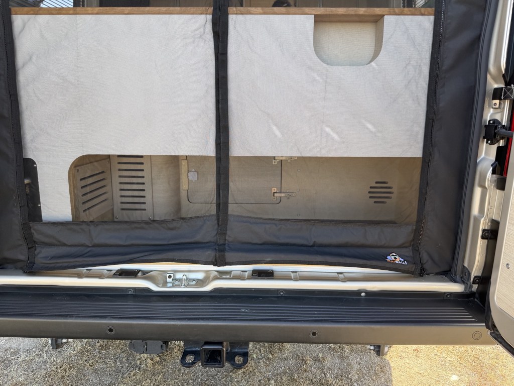 Garage space, covered by bug screen; outdoor shower on left Garage space, covered by bug screen; outdoor shower on left