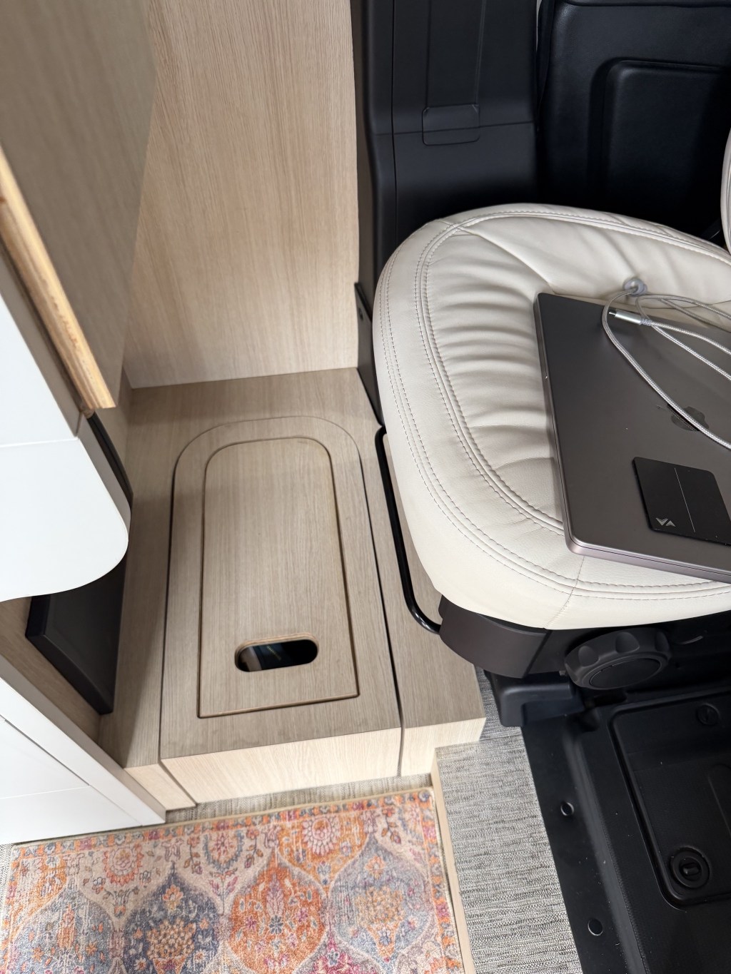 Pull-out storage bin below desk, that can be used as a step