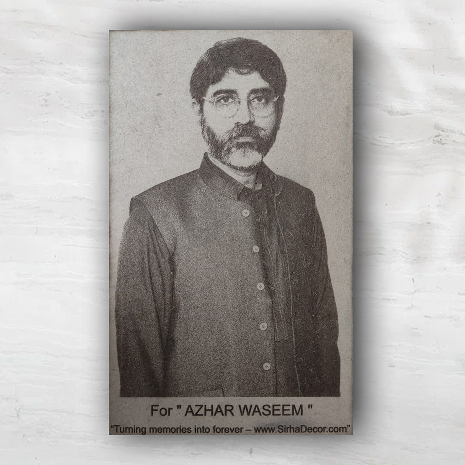 Personalized laser engraved wooden portrait hanging on a white textured wall as custom rustic home decor.