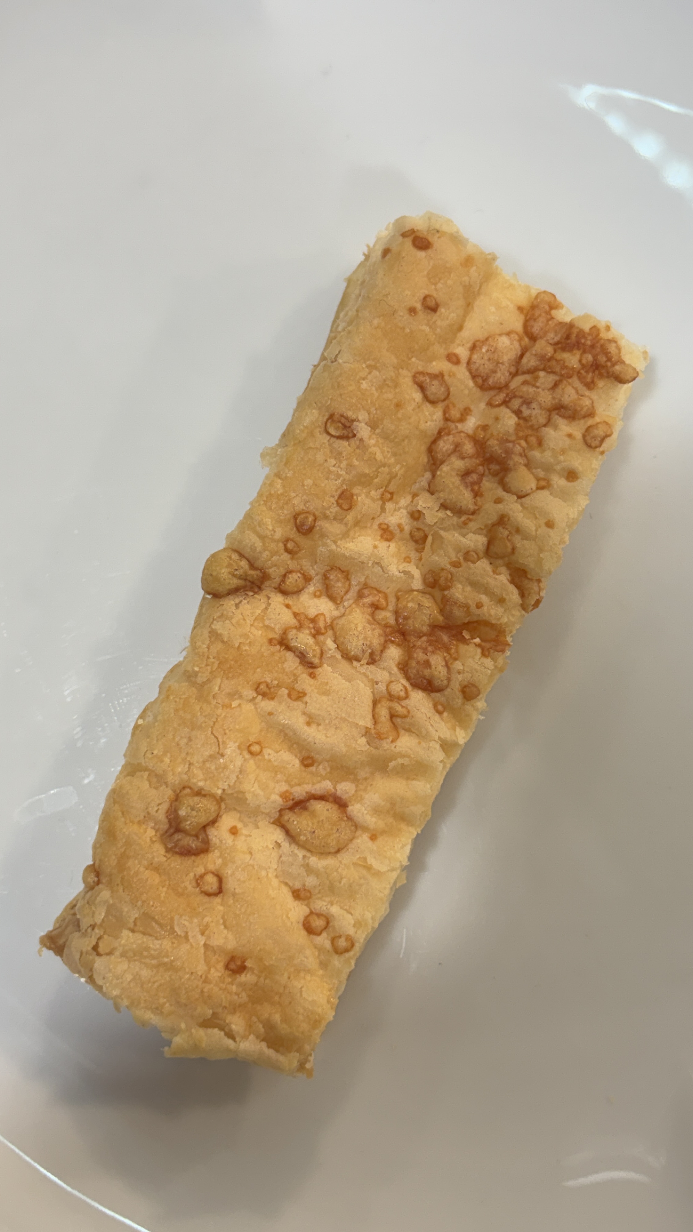 Golden Parmesan puff pastry showing a crisp cheese-topped surface