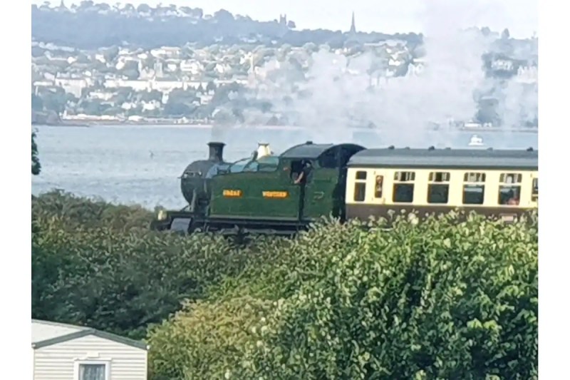 Dartmouth steam train passing a caravan park near Paignton