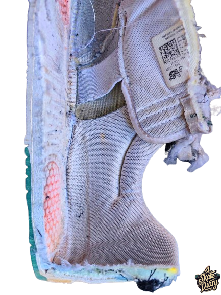 Inside view of New Balance 425 white leather shoe showing cushioning layers and structural reinforcement