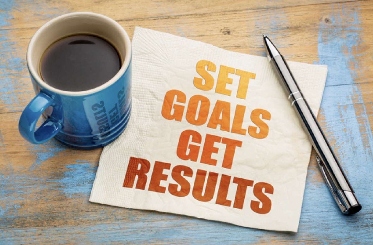 Coffee on a napkin that says Set Goals, Get Results.