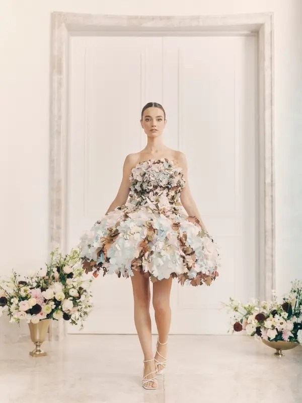 Photographed by Kelly Taub, a model walks down the runway in the Gown of Seasons, each step setting the silk leaves in motion. The dress moves like wind through aspen trees, ripples over water, and shifting clouds in the sky, yet its structure remains—rooted, still, evolving. A convergence of earth, water, and sky, the gown embodies the quiet rhythm of transformation.