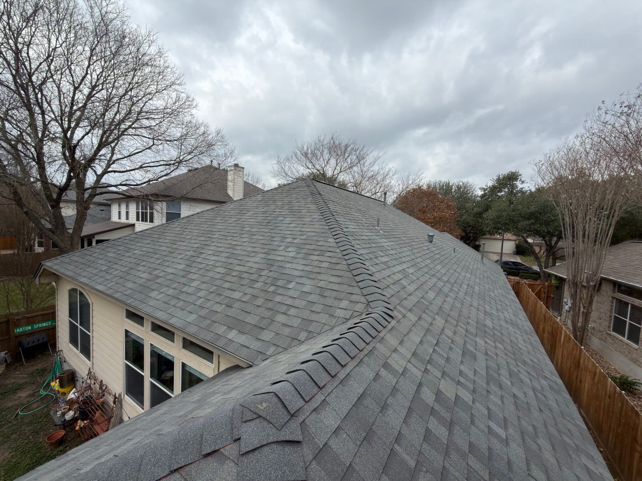 Gray shingled roof under cloudy - Owens Corning - Shingle Roof - Skywall Construction