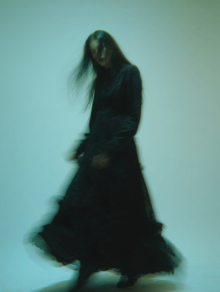 blurry image of dark haired figure