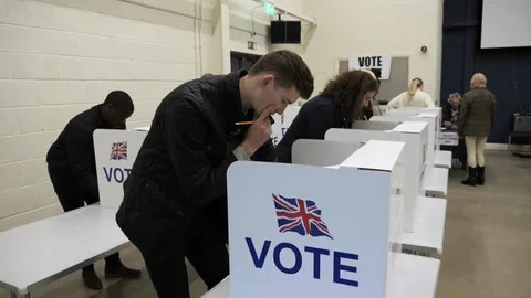 People voting at british poll station