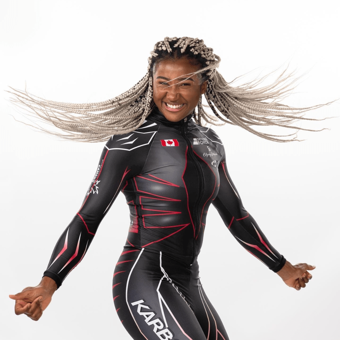 Bobsledder Dawn Richardson Wilson standing in the middle, mid-spin.