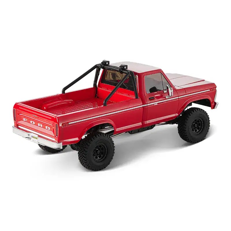 Small-scale RC Ford F-100 truck with off-road tires and roll cage.