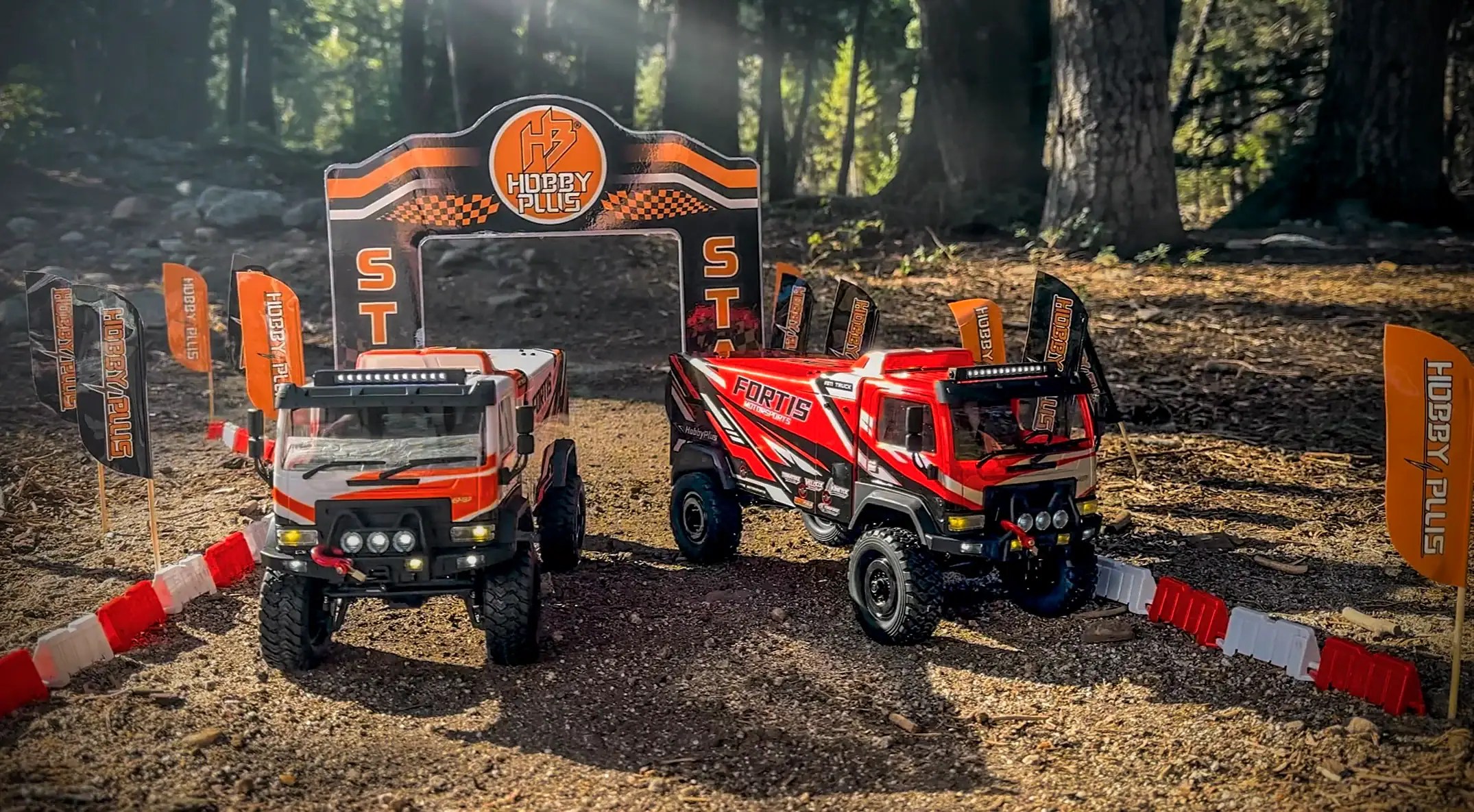 Small-scale RC desert rally trucks on a dirt track in a forest setting.