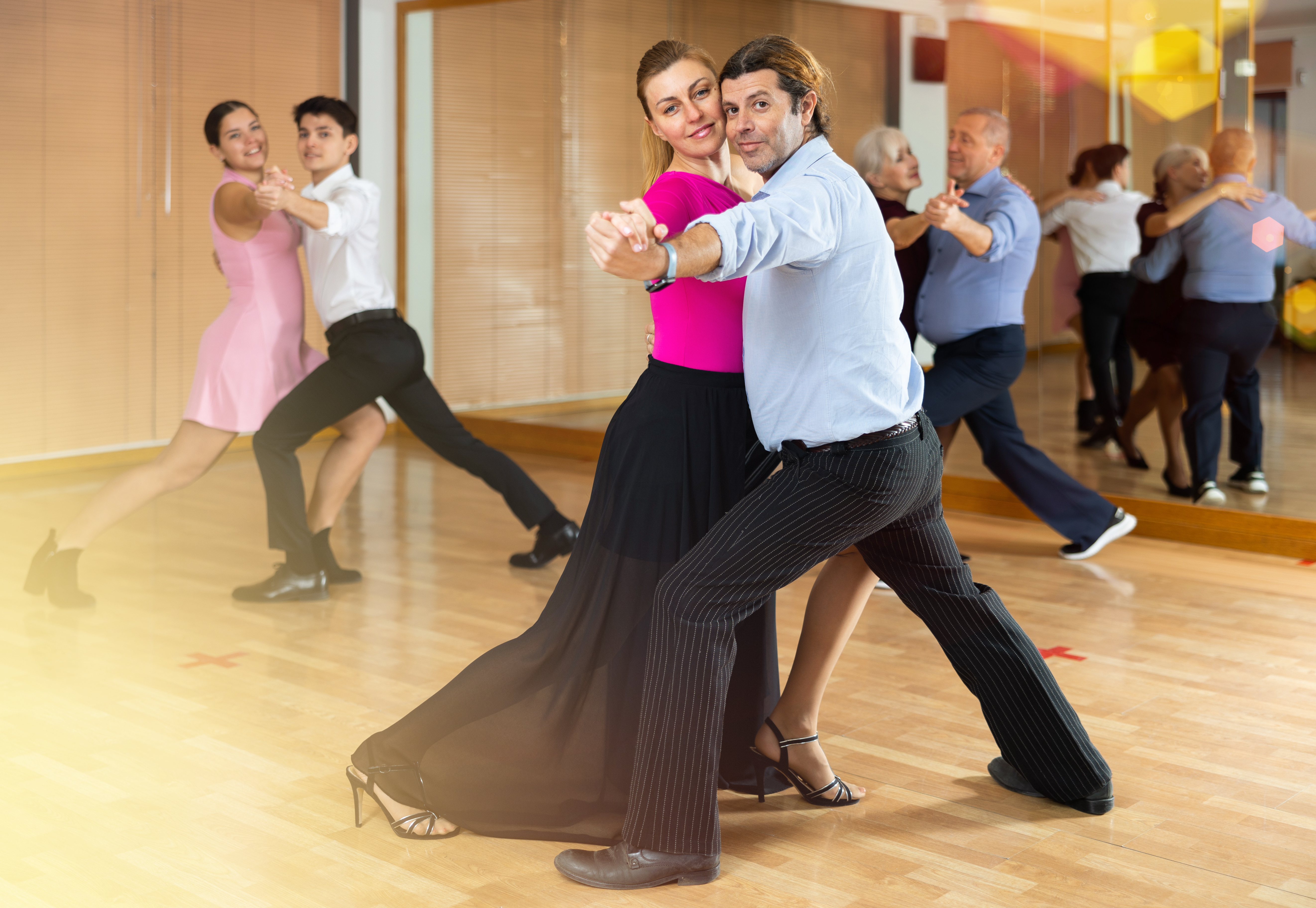 Couple practicing ballroom dance together during a lesson