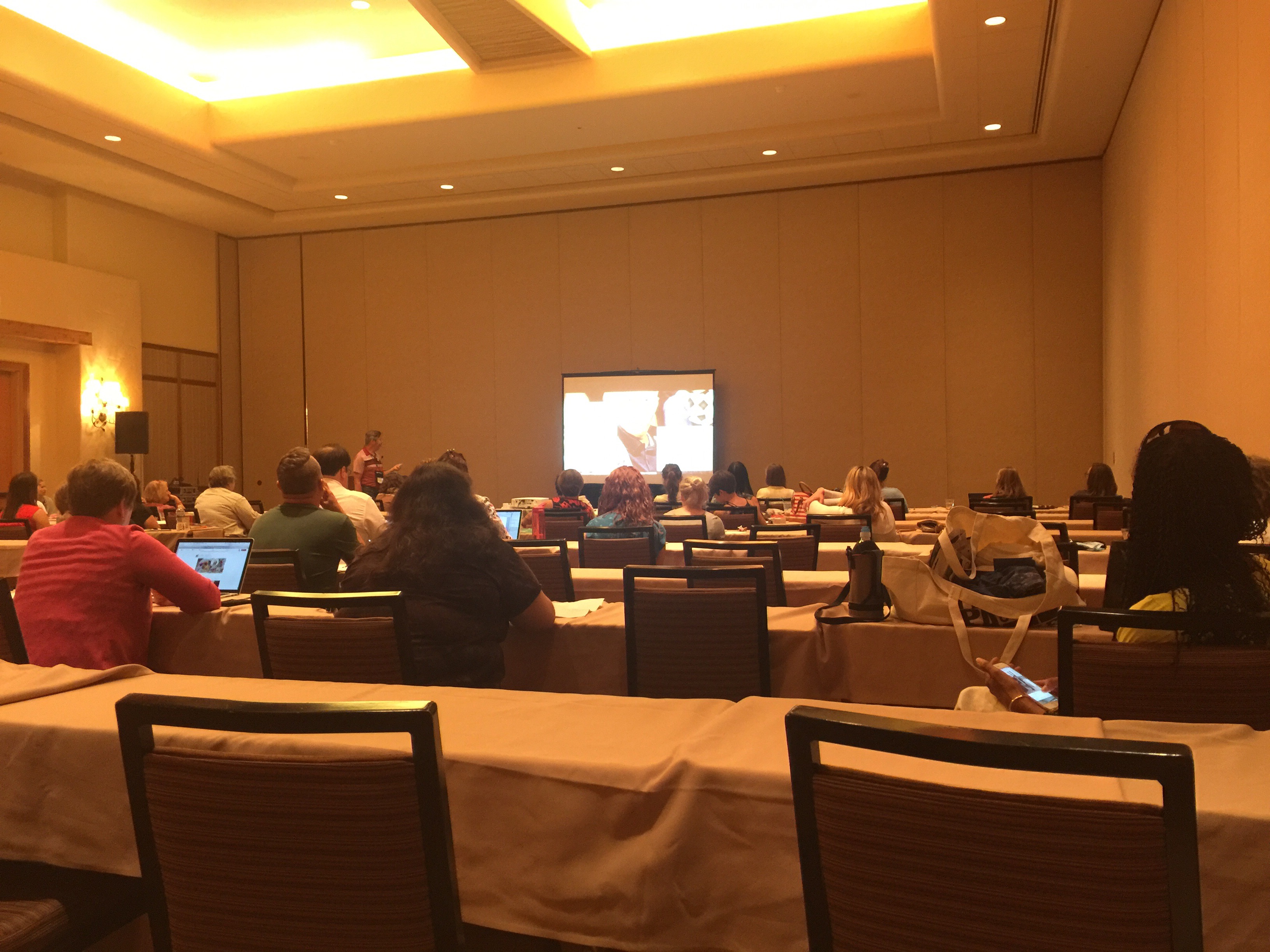 A seminar in a hotel conference room.