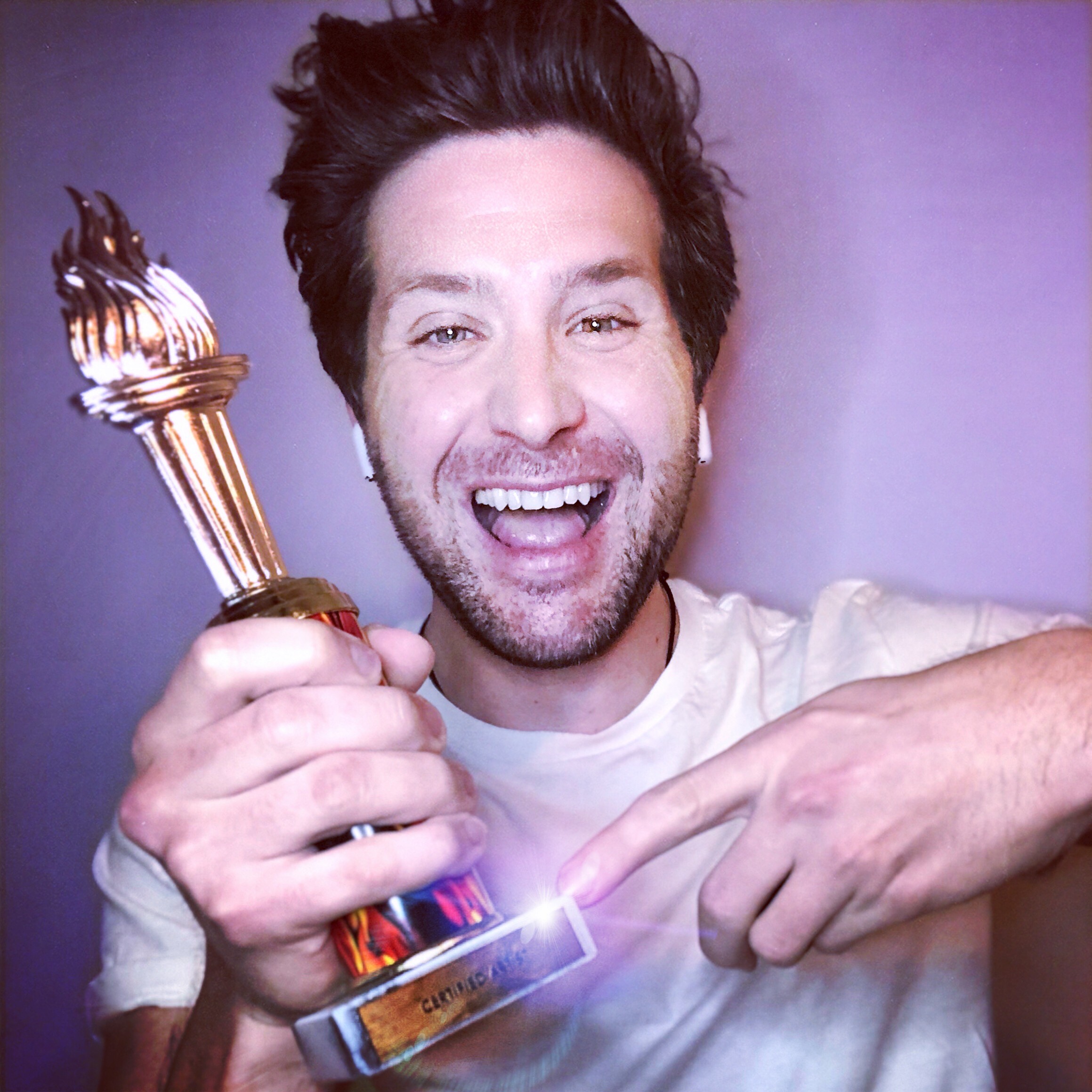 SND Board Member Yuri Victor sports a big smile and is points to a trophy he's holding. We're not sure what the trophy is for, but he looks happy about receiving it.