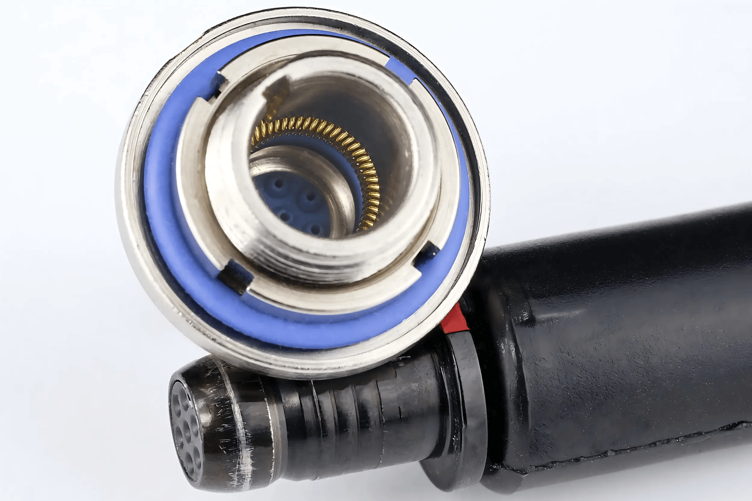Canted coil spring installed in an electrical connector contact interface