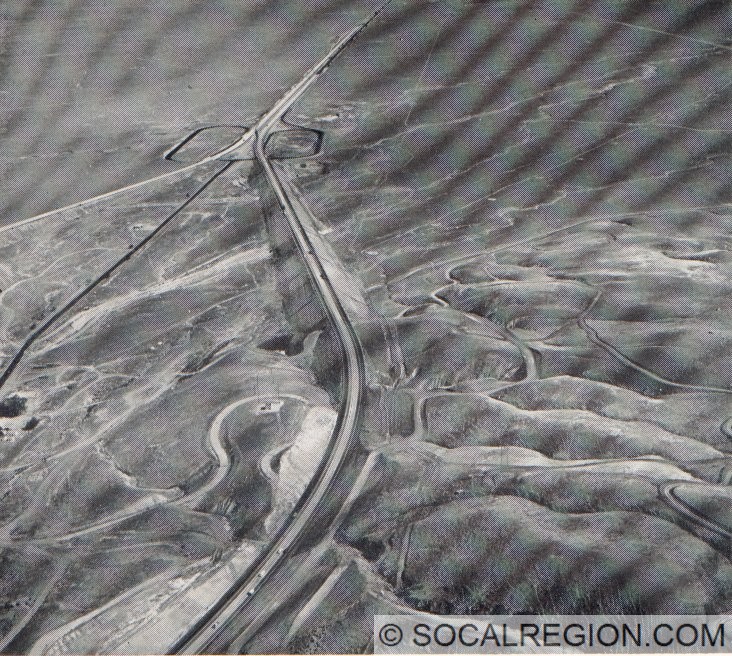1960 view of "The Loop" curve sliced through by the new northbound lanes on I-5. Grapevine (1960) is at the point the sides of the freeway converge.