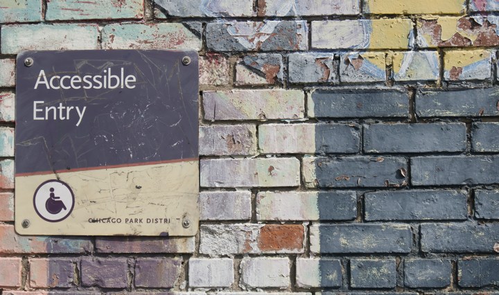 A colourful wall with a sign that says: accessible entry