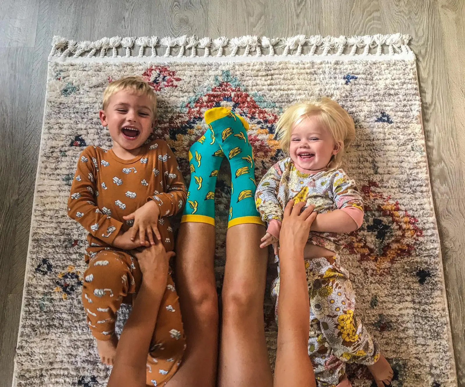 Kids smiloing with mother wearing bannna socks