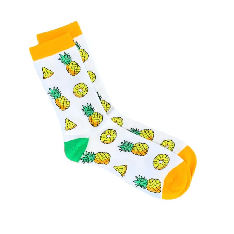 Yellow pineapple sock design on a white background with orange toe and cuff. Heel is green.