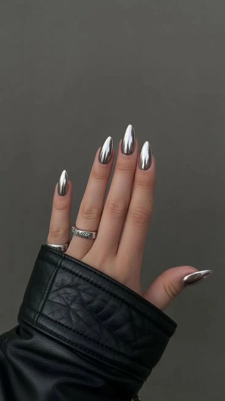Almond-shaped nails with a bright, reflective silver chrome finish.