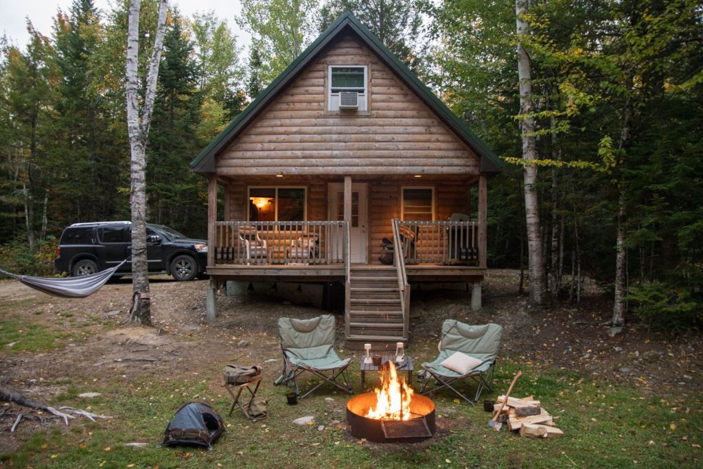 cabin at Wild Fox Cabins campground with fire pit and chiars