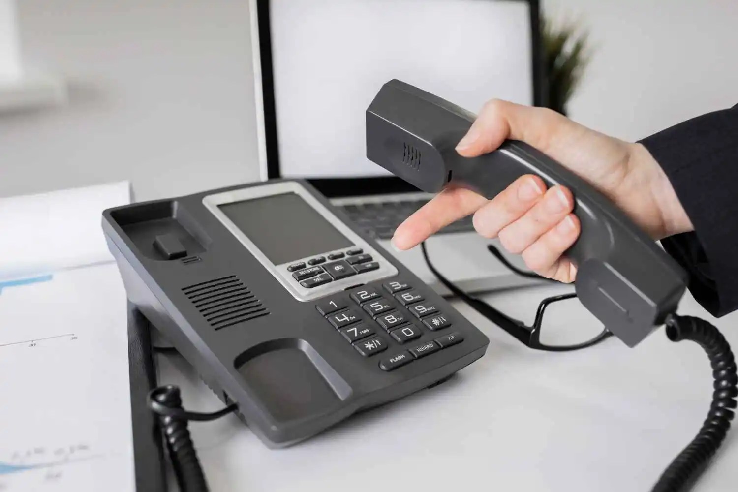 A man pick up receiver of black phone