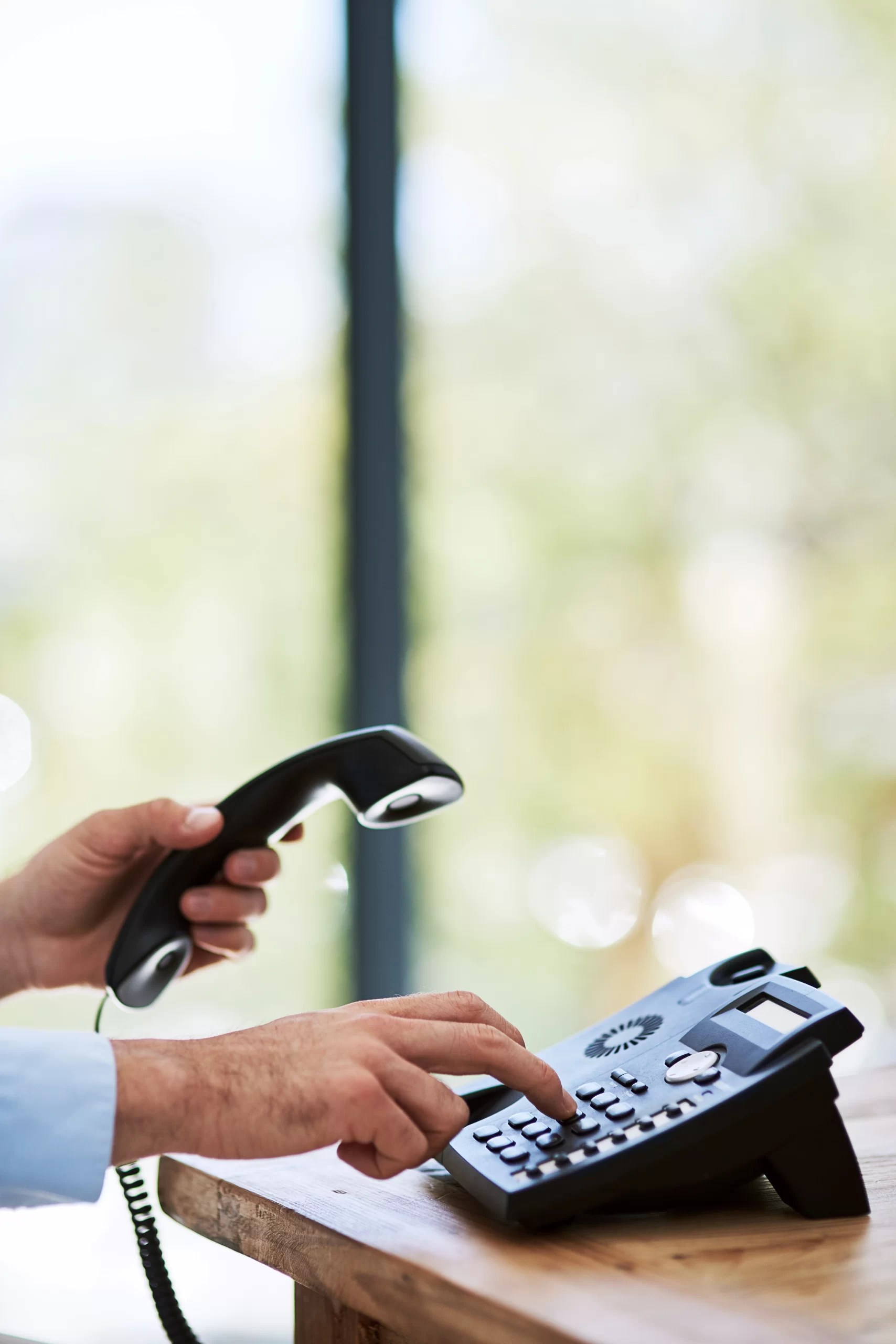 A man pick up the receiver of phone set.