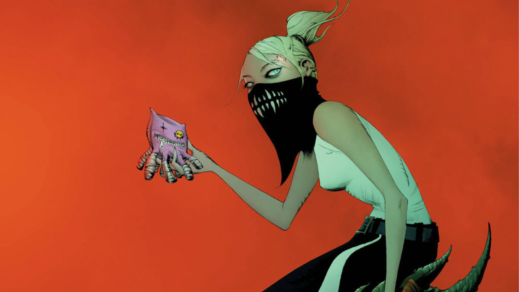 Erica Slaughter from Something Is Killing the Children holding up a stuff animal octopus.