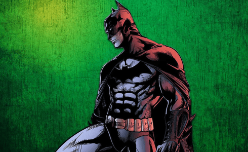 Batman stands in front of green wallpaper.