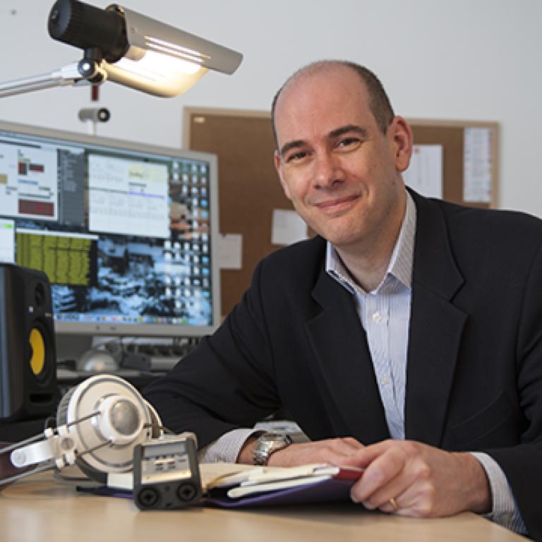 Paul Vickers sitting at a desk.
