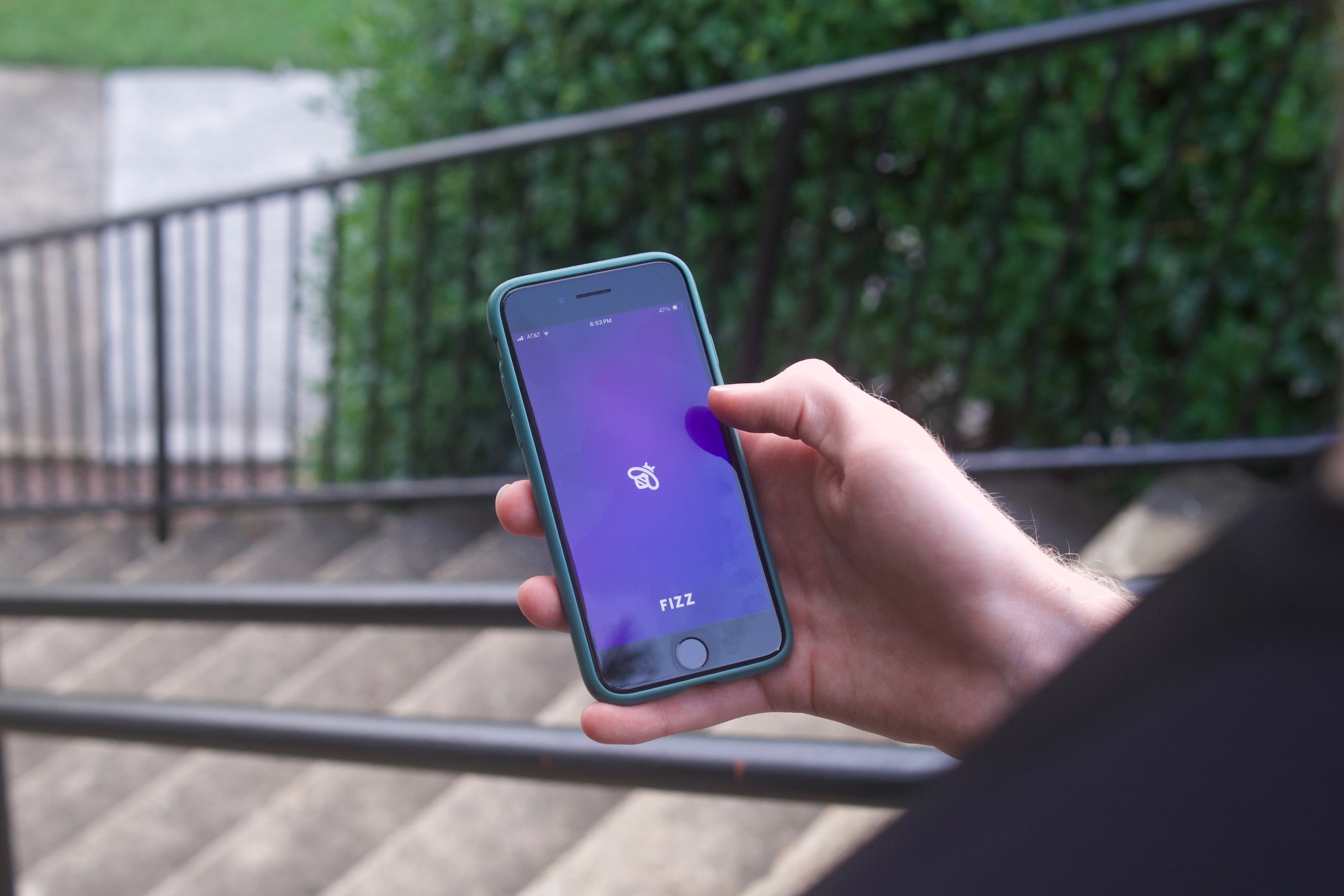 Student opens their phone to Fizz, an anonymous social platform for college students. (Photo by Asher LeVos).