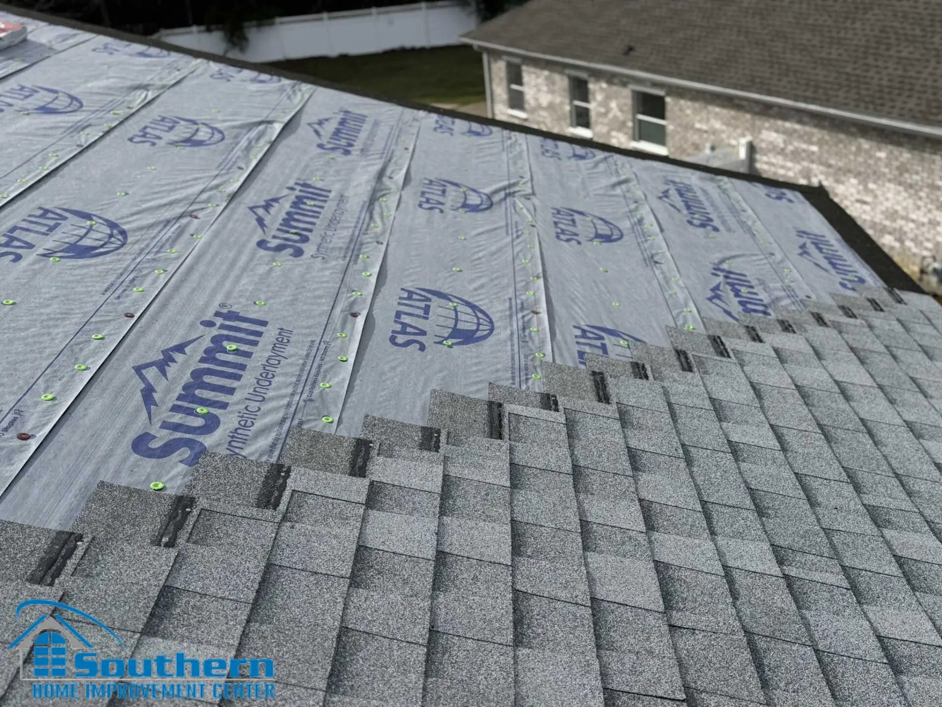 Atlas Summit synthetic underlayment installed across the roof plane with cap fasteners before shingle installation on a Slidell, LA home.