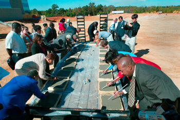 New hospital, Lithonia, Georgia, October 23, 2003. VIPs sign cement during the foundation pouring ceremony at South DeKalb Medical Center for the first full-service hospital in south DeKalb. Photograph by HIP Incorporated © 2003. New hospital, Lithonia, Georgia, October 23, 2003. VIPs sign cement during the foundation pouring ceremony at South DeKalb Medical Center for the first full-service hospital in south DeKalb. Photograph by HIP Incorporated © 2003.