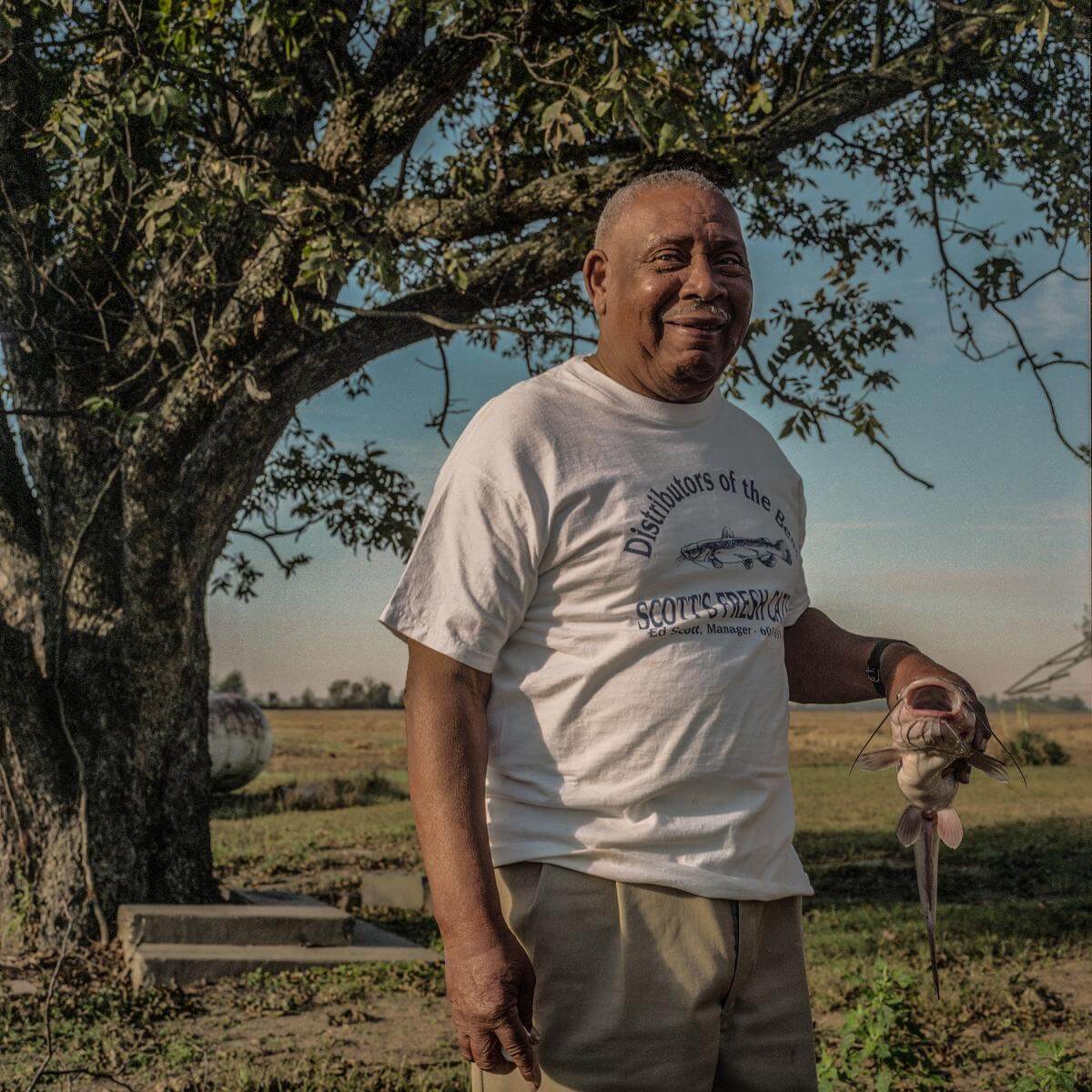 Ed Scott Jr. with catfish, Leflore County, Mississippi, 2001. Photograph by Maude Schuyler Clay. © Maude Schuyler Clay. Ed Scott Jr. with catfish