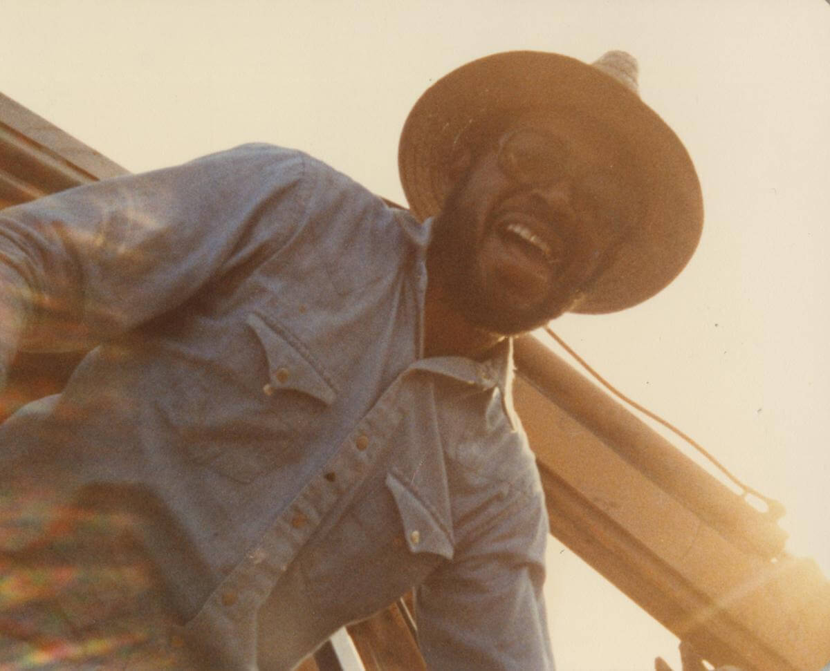 Isaac Scott, Leflore County, Mississippi, ca. 1983. Photograph by unknown creator. Originally published in Julian Rankin's Catfish Dream: Ed Scott's Fight for His Family Farm and Racial Justice in the Mississippi Delta (University of Georgia Press, 2018). Courtesy of Willena Scott-White. Isaac Scott smiling down at the camera