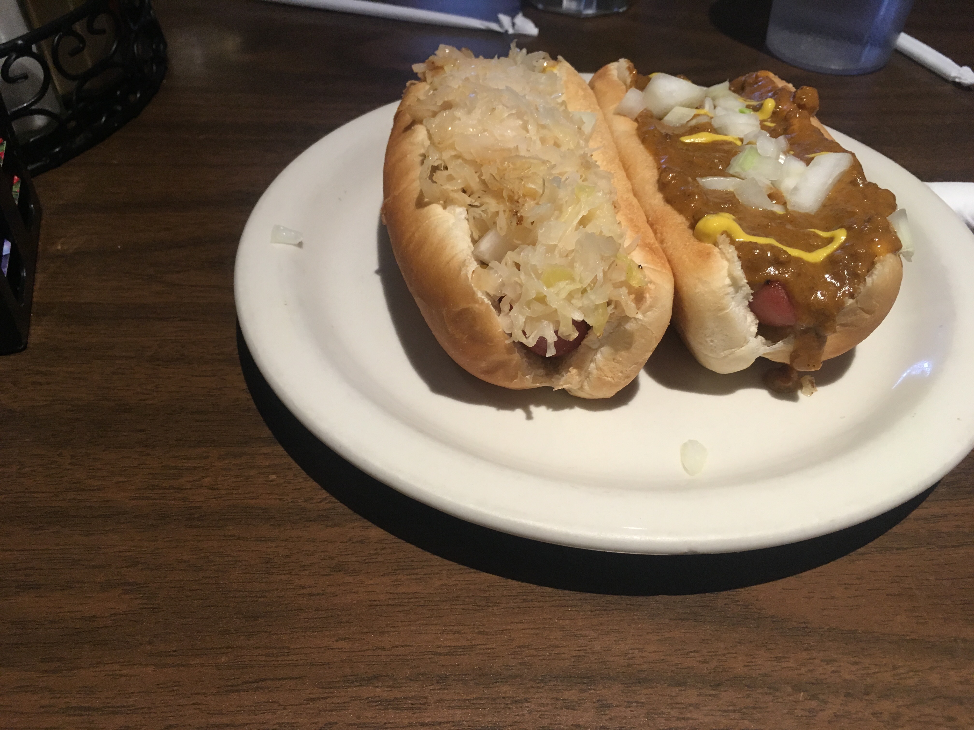 Pictured here are two of T & D Coney Grill's coney dogs. The left is topped with sauerkraut, mustard and onion. The right is topped with chili, mustard, and onion. Photo by Jamal Tyler.