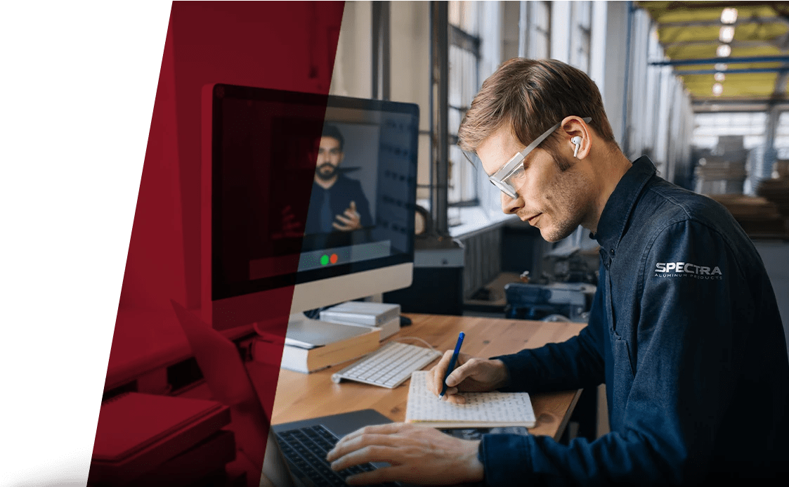man on computer video call in factory
