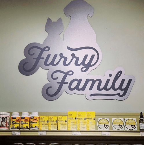 Shelf displaying stylish signage and decorative bottles, highlighting artistic font design.