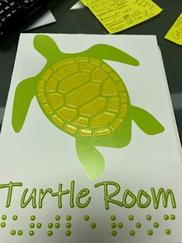 White sign featuring a detailed turtle illustration on paper background