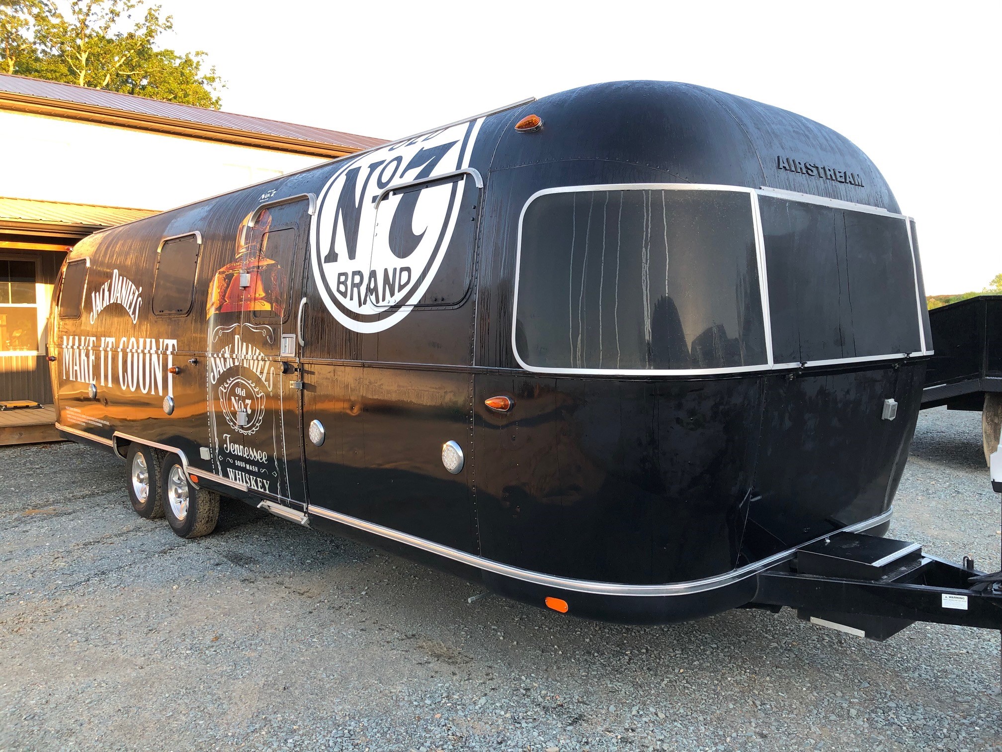 Black trailer with logo featuring an advanced automotive wheel system