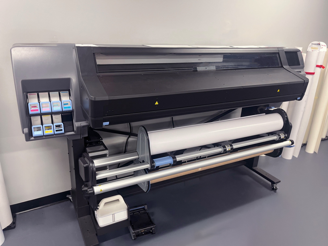 Advanced technology machine: large printer with paper roll for high-quality printing.